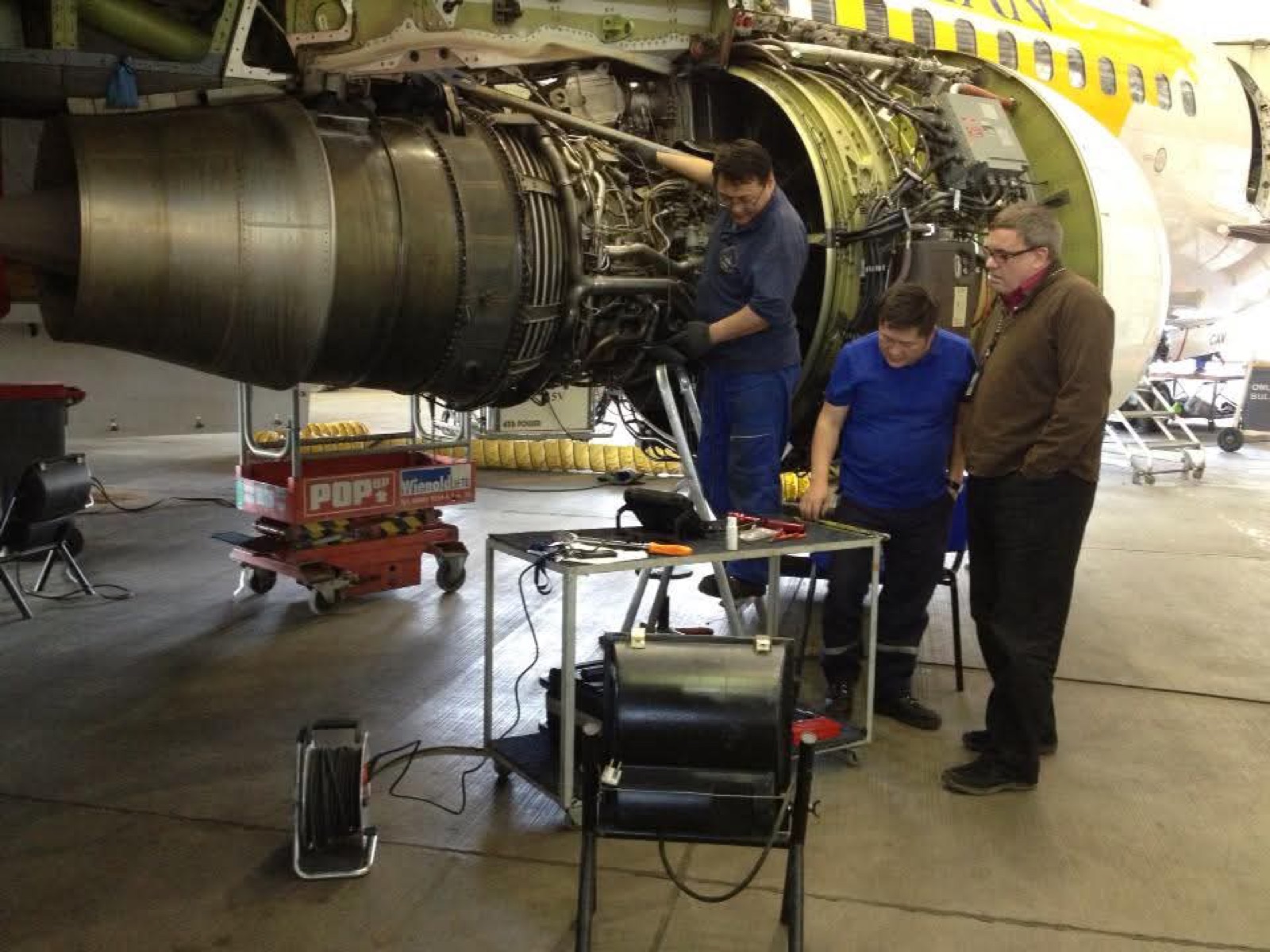 Maintenance team working on an aircraft engine